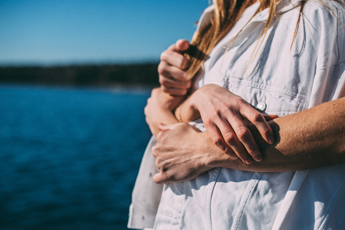 Person applying Gun Ana UV Stick to a forearm outdoors